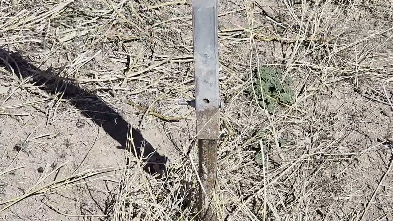 A weathered farm tool driven into the soil